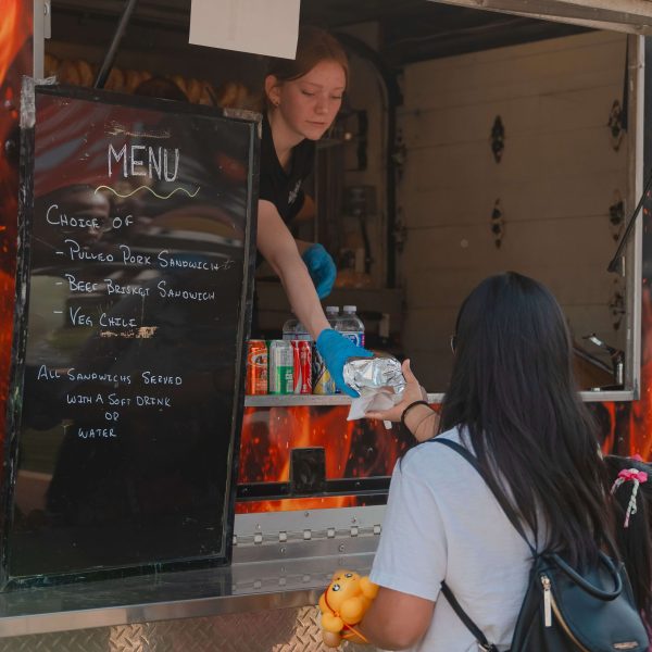 Food truck handing over food at Trumpeter showhome opening event in 2025